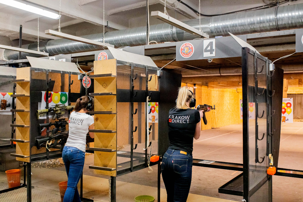 Tourists at Krakow Shooting Range aiming rifles downrange during a Krakow Direct tour
