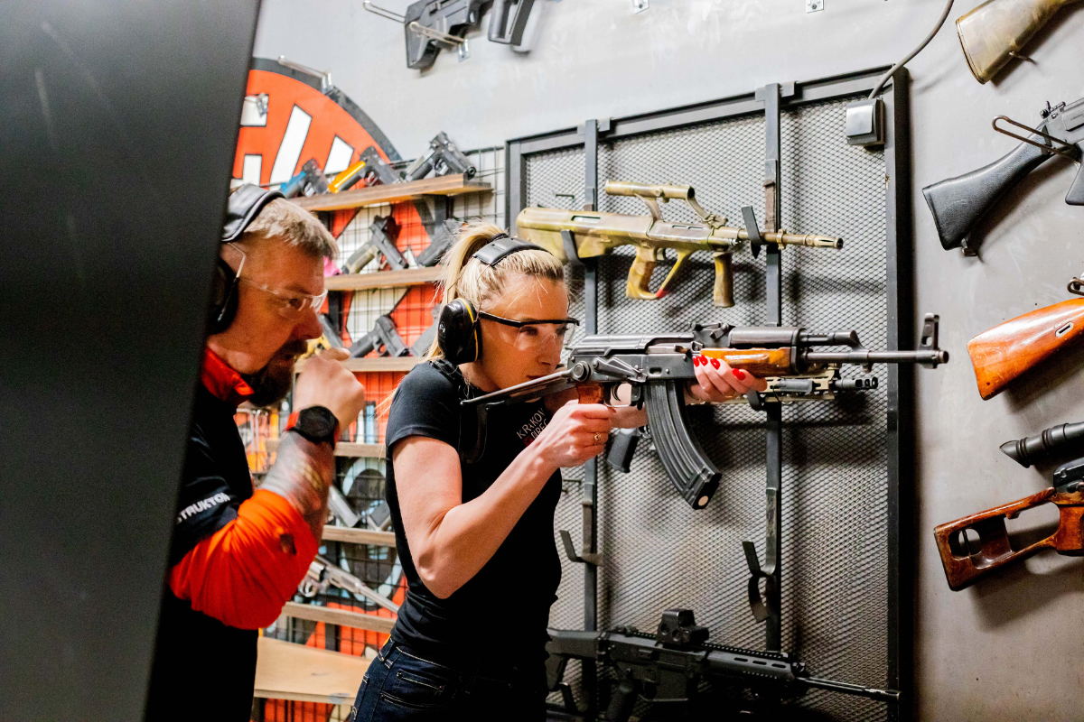 Krakow shooting instructor teaching how to properly hold and shoot an AK-47 at the shooting range.