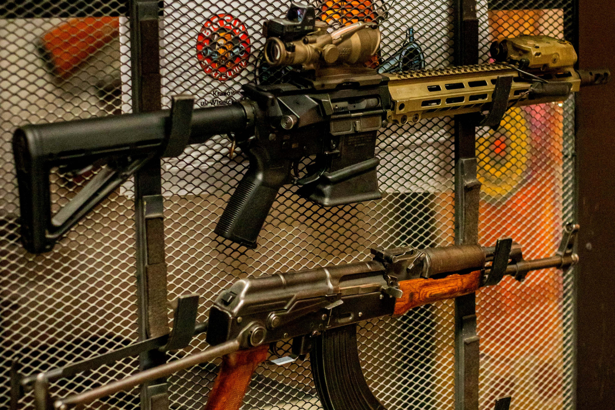 A variety of long guns and rifles displayed on a rack at the Krakow shooting range.